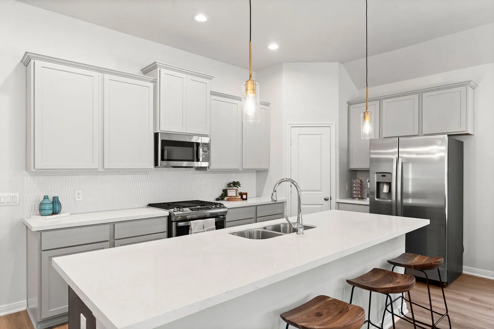 Modern kitchen with white cabinets and granite countertops in Alta Homes new home